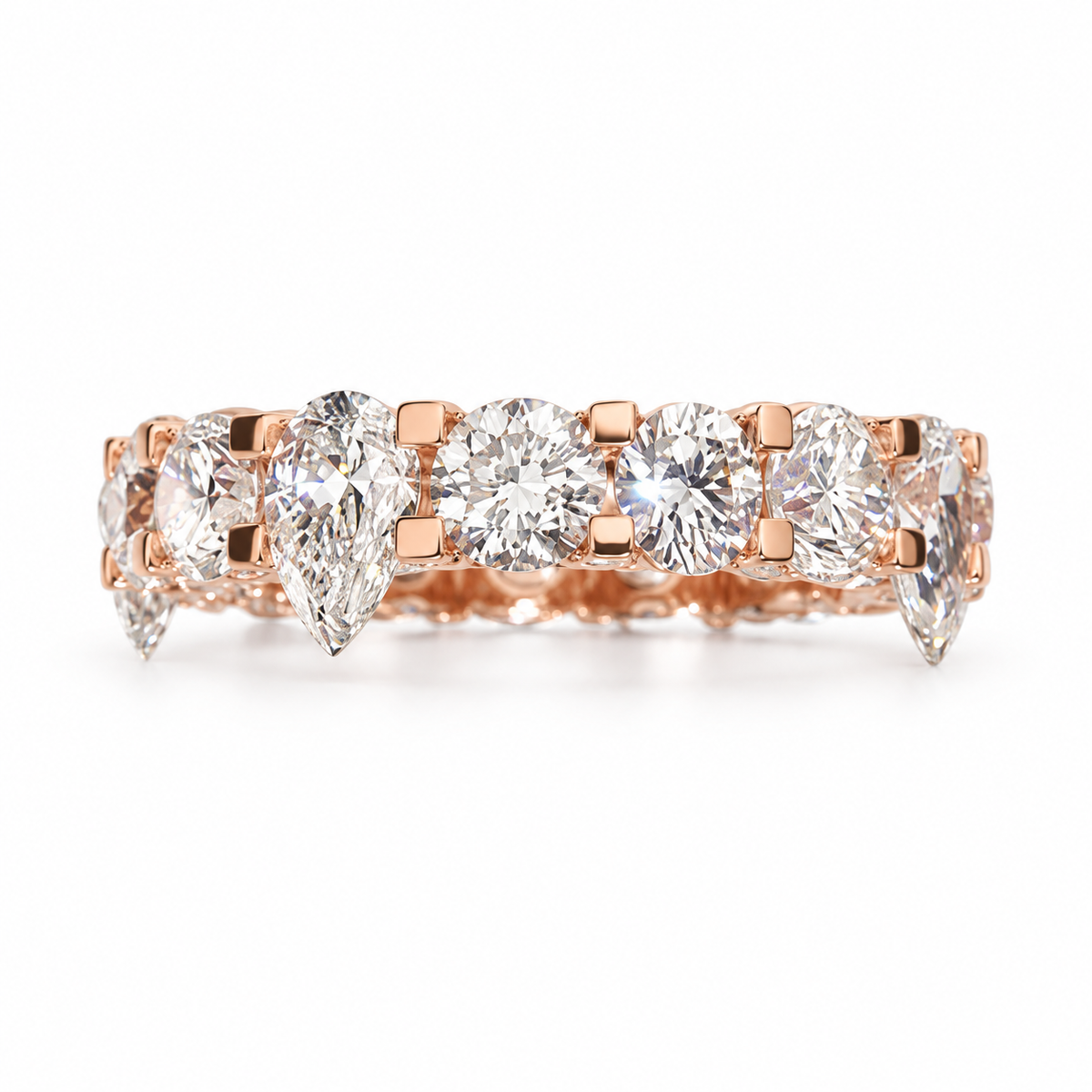 A rose gold eternity ring featuring a row of brilliant round and pear-cut diamonds in a prong setting, shown against a clean white background.