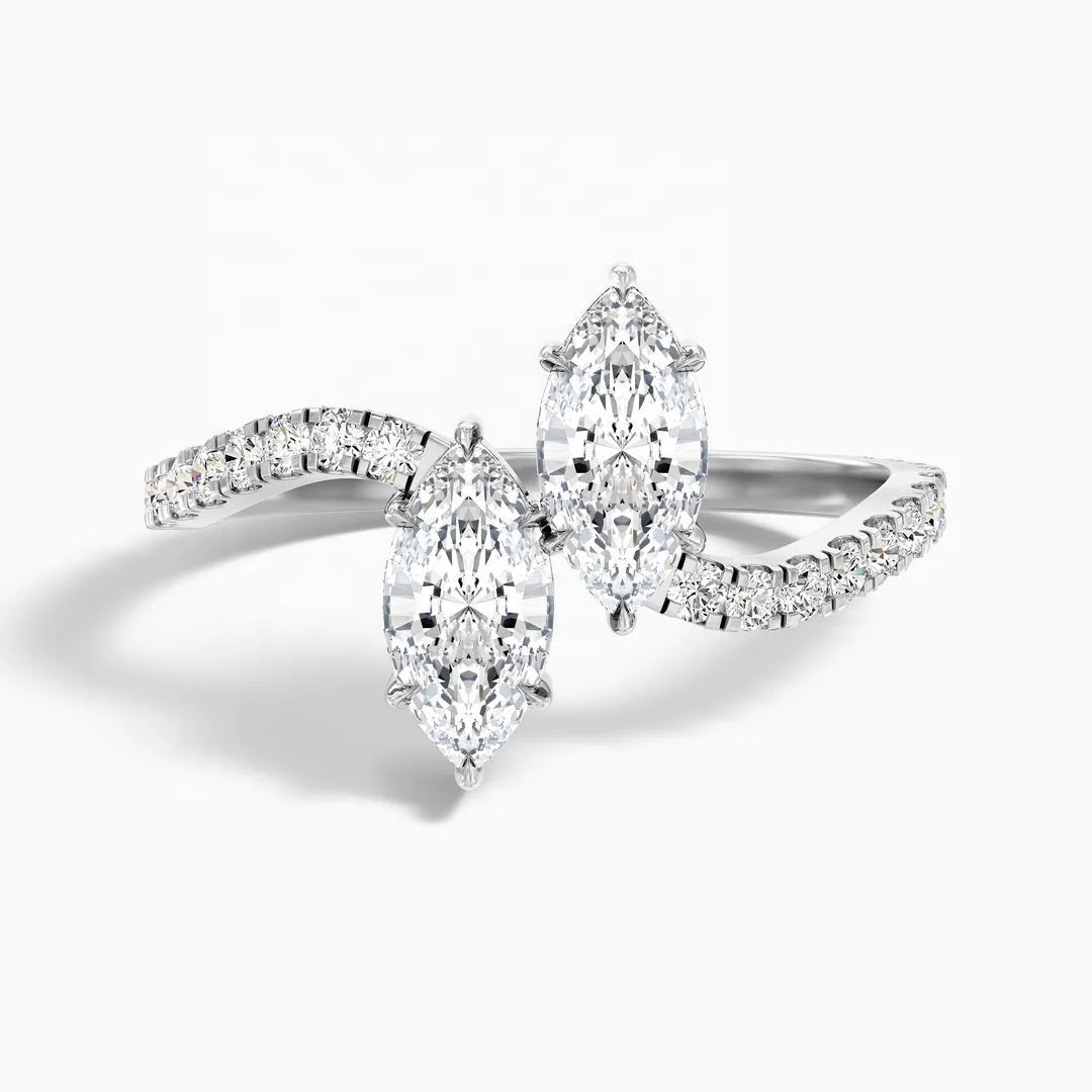 A silver-tone diamond ring featuring three marquise-cut diamonds and smaller pavé-set diamonds on a clean white background.
