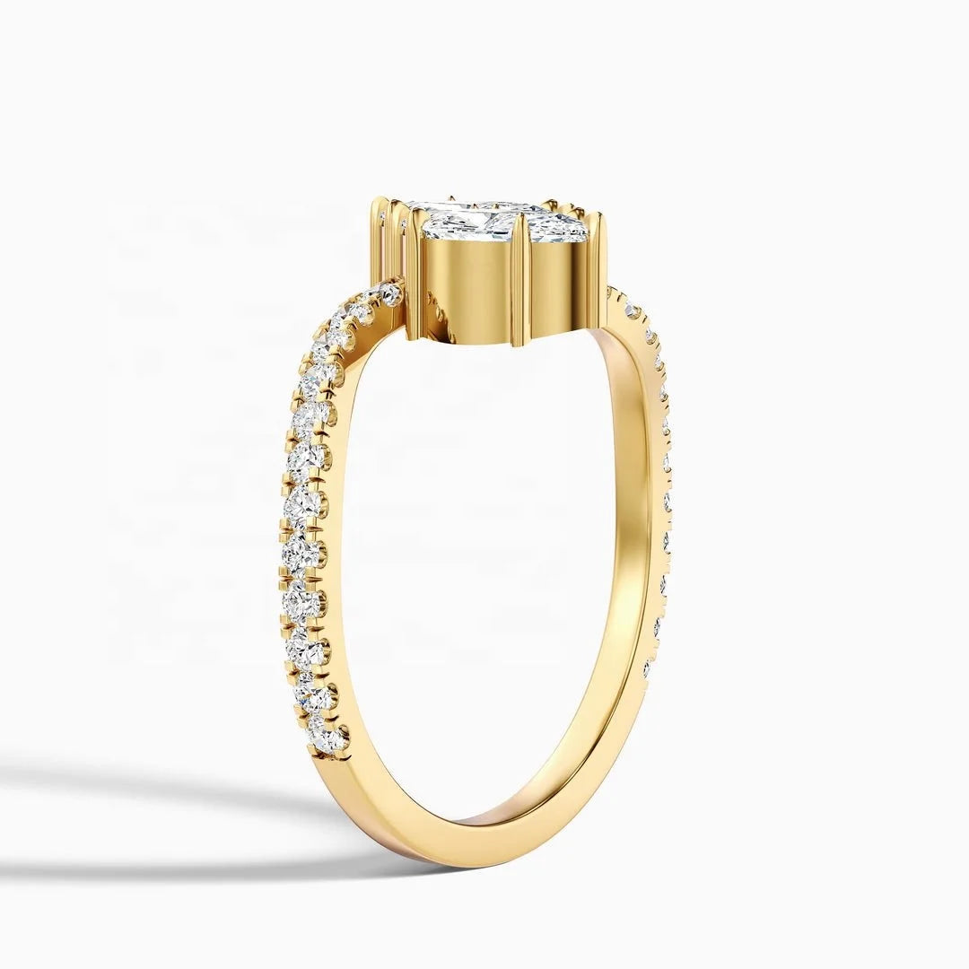 A yellow gold diamond ring with a round brilliant-cut center stone and a pavé band set with small diamonds, shown on a clean white background.