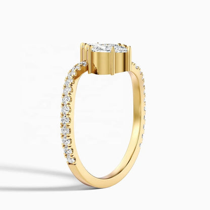 A yellow gold diamond ring with a round brilliant-cut center stone and a pavé band set with small diamonds, shown on a clean white background.