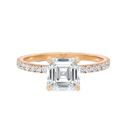A rose gold engagement ring featuring a large emerald-cut clear center stone and a pavé-set diamond half-shank, shown on a clean white background.