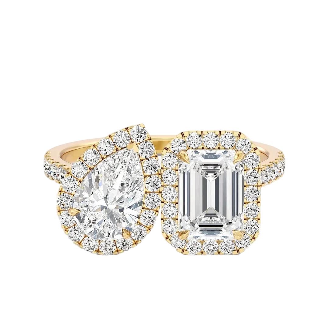 Two diamond rings with gold and emerald cut stones on a white background
