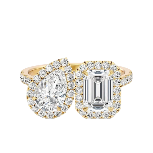 Two diamond rings with gold and emerald cut stones on a white background
