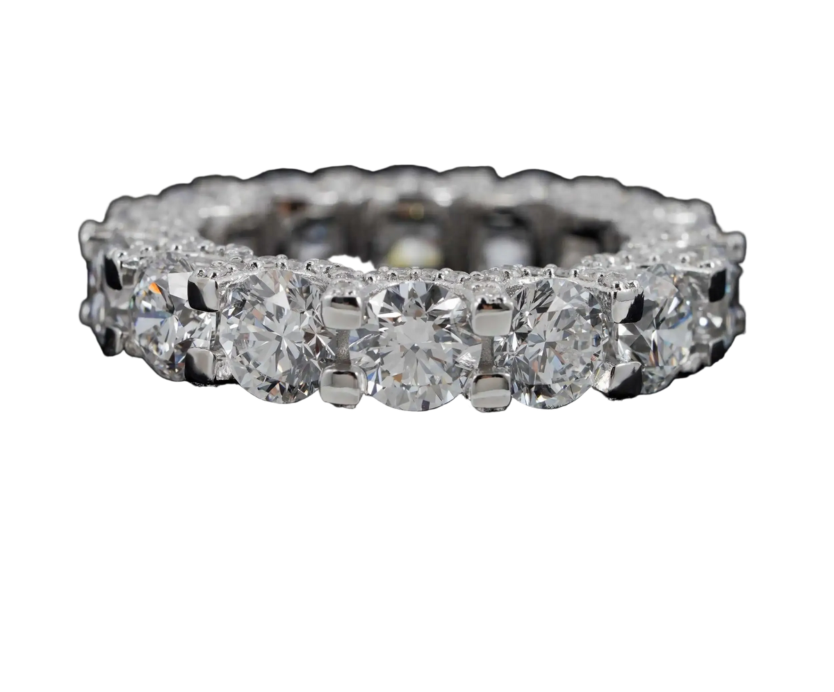 A diamond eternity ring set in silver-colored metal, featuring a continuous row of round brilliant-cut diamonds on a black background. The ZUANFA logo is visible in the top-left corner.