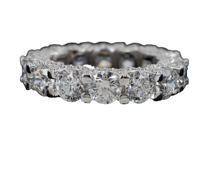 A diamond eternity ring set in silver-colored metal, featuring a continuous row of round brilliant-cut diamonds on a black background. The ZUANFA logo is visible in the top-left corner.