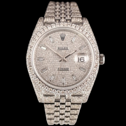 A Rolex Datejust watch with a diamond-encrusted silver-tone bracelet and textured dial, shown against a light gray draped background.